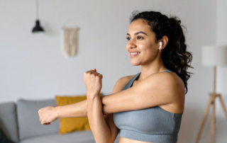 Woman performing gentle seated stretch for hypermobility and chronic pain support